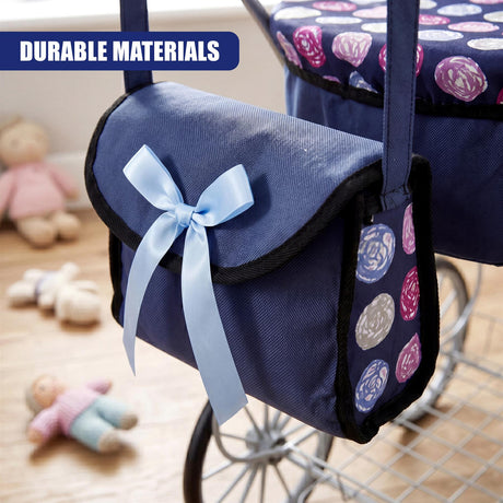 Blue canvas storage pouch attached to a pram, featuring a bow and patterned side panels.