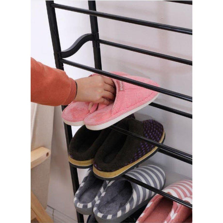 A shoe rack with multiple pairs of shoes hanging from it.