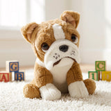 Soft toy of a brown British Bulldog puppy sitting on a white rug with alphabet blocks.