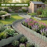 The light green garden fence lines a gravel path among various colorful perennial flower beds.