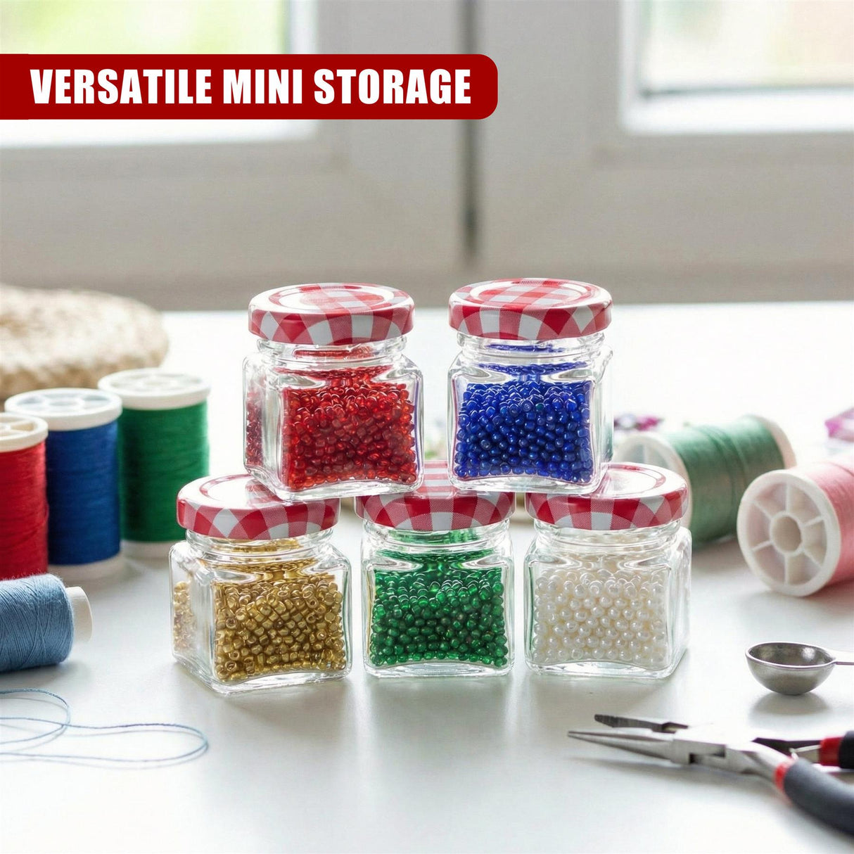 Five small glass jars containing colorful beads, placed among craft supplies and threads.