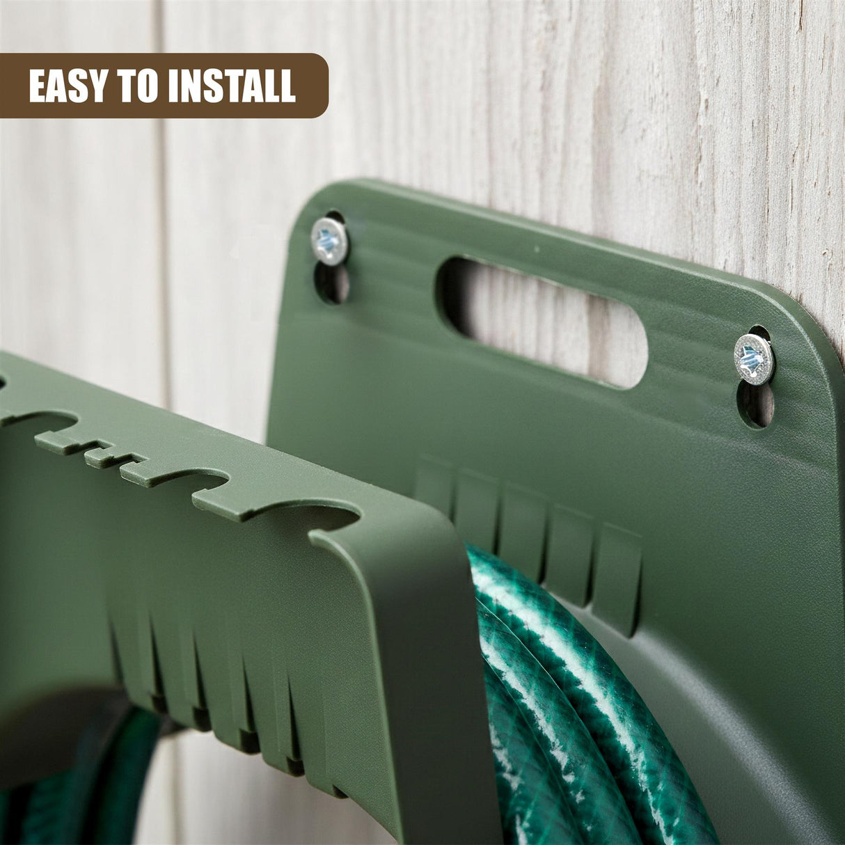 Dark green garden hose holder with mounting holes and slots, supporting coiled green hoses.