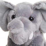 Light gray plush toy of an elephant with floppy ears, tusks, and large eyes.