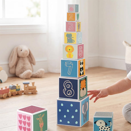 A tower of stacking cubes displays numbers and various animals, built on a light wooden floor.