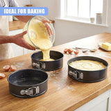 Kitchen countertop displays three springform cake pans and batter being poured into one.