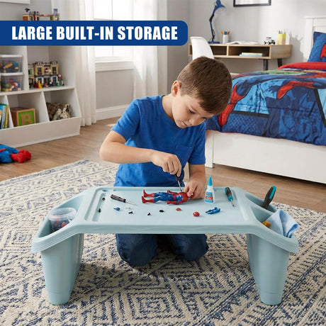 A kid in a blue shirt working on a bed tray table with storage, surrounded by toys and construction materials. - UKBuyZone