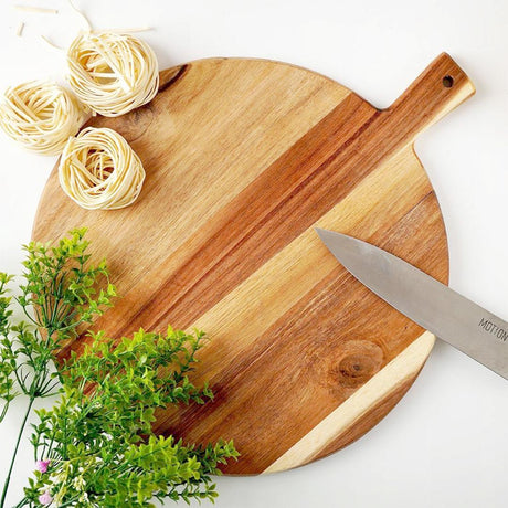 "Knife on a board, with herbs in the background." - UKBuyZone