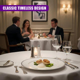 Two salt and pepper shakers flank a plate holding food and cutlery on a white dining tablecloth.