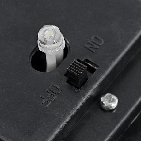 Black outdoor light fixture showing a socket, a mechanical ON/OFF switch, and labels.