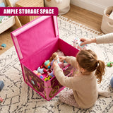 A young girl places toys into a large pink foldable storage box with a princess carriage design on a patterned rug