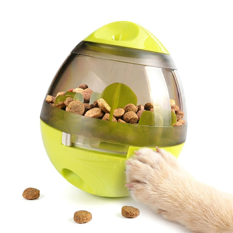 Lime green dog treat dispenser filled with kibble, shown with a paw resting nearby.