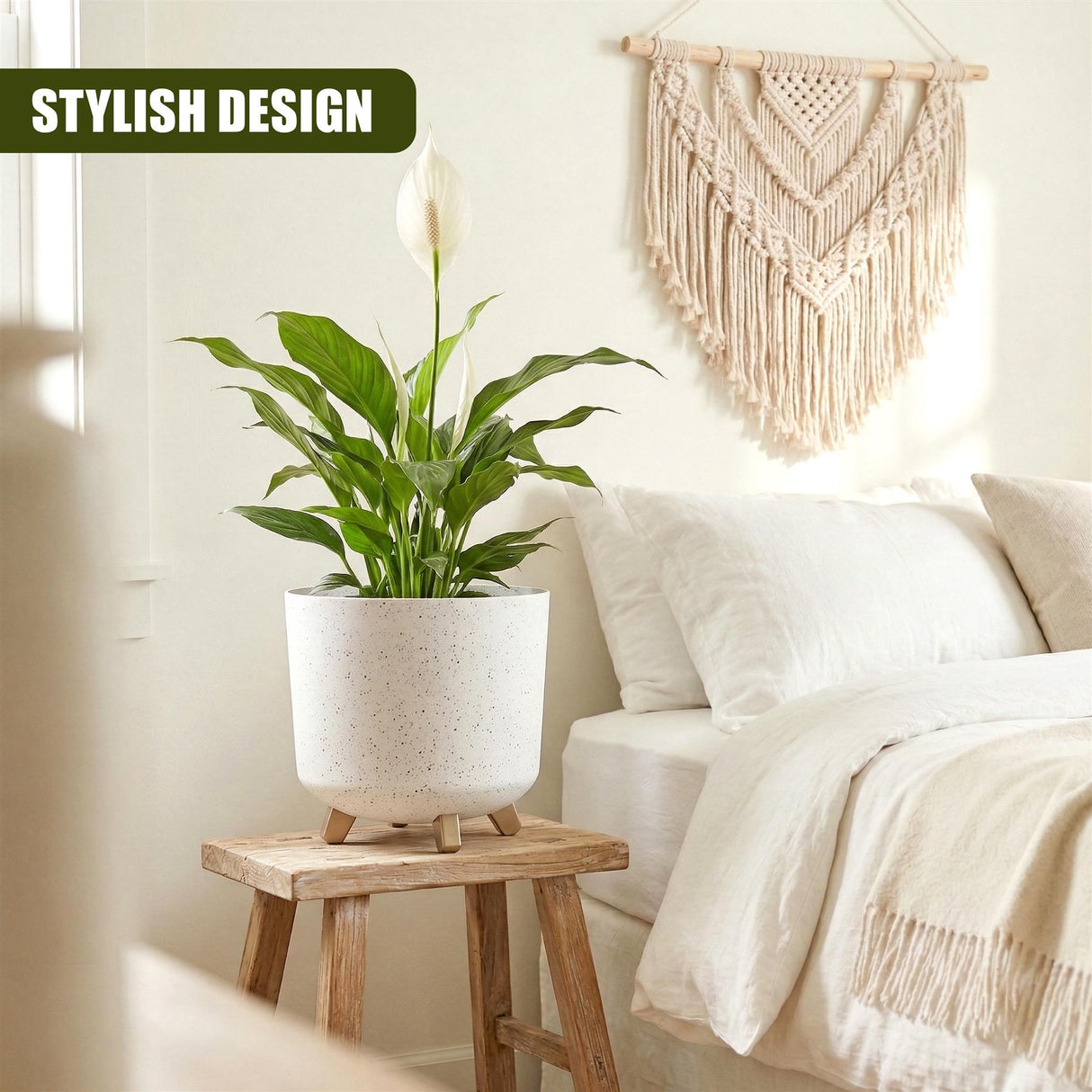 White ceramic pot with plant sits on wooden stool next to bed.