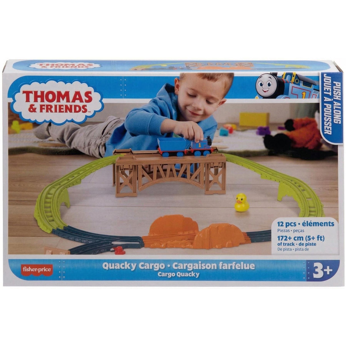 A boxed toy set featuring a blue train, green tracks, a cargo piece, and a bridge structure.