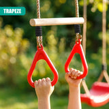 Child's hands grip red trapeze hangers suspended beneath a horizontal wooden bar.