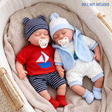 Two dolls rest in a basket, modeled in coordinating baby outfits of red and blue stripes.