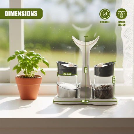 Three contrasting kitchen shakers holding white salt and black pepper on a windowsill.