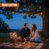 Solar string lights strung across tree branches illuminate an outdoor evening gathering.