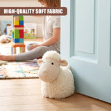 Fluffy white sheep door stopper rests against a light blue doorframe on a wooden floor.
