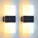 Pair of vertical wall sconces featuring illuminated acrylic panels and dark, slotted rectangular base fixtures.