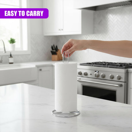 A hand reaches into the frame adjusting the white paper roll on a chrome kitchen stand.