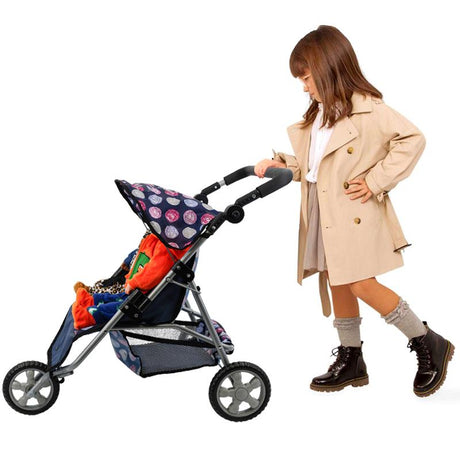 Beige-coated girl standing by a blue, three-wheeled toy pushchair with patterned seats.