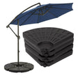Dark blue cantilever umbrella shown with its pole and a stack of three patterned round bases.