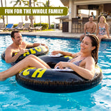 A black inflatable tire ring with yellow lettering floats in a blue swimming pool.