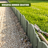 Green garden edging fence separates gravel path from lush green grass.