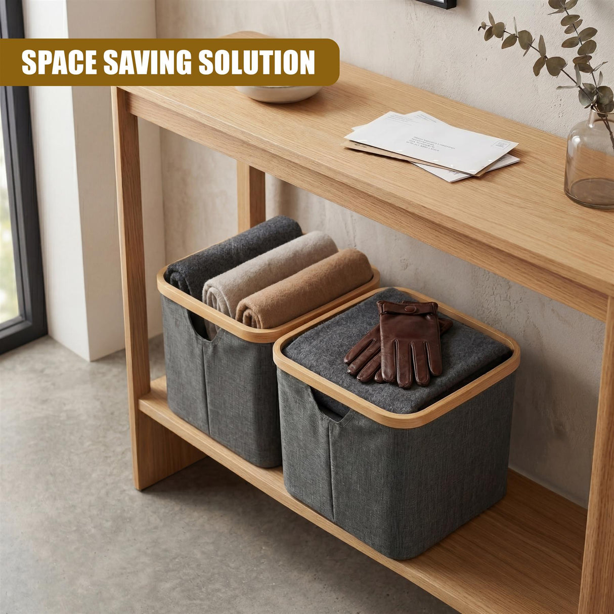 Two gray fabric storage bins rest on wood, containing rolled towels and a pair of brown gloves.