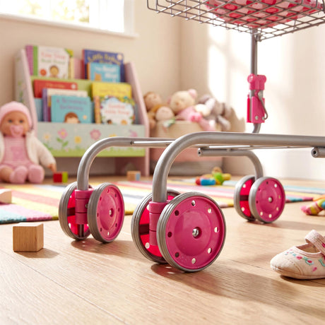 Pink caster wheels attached to a metal frame support a kids doll shopping trolley.