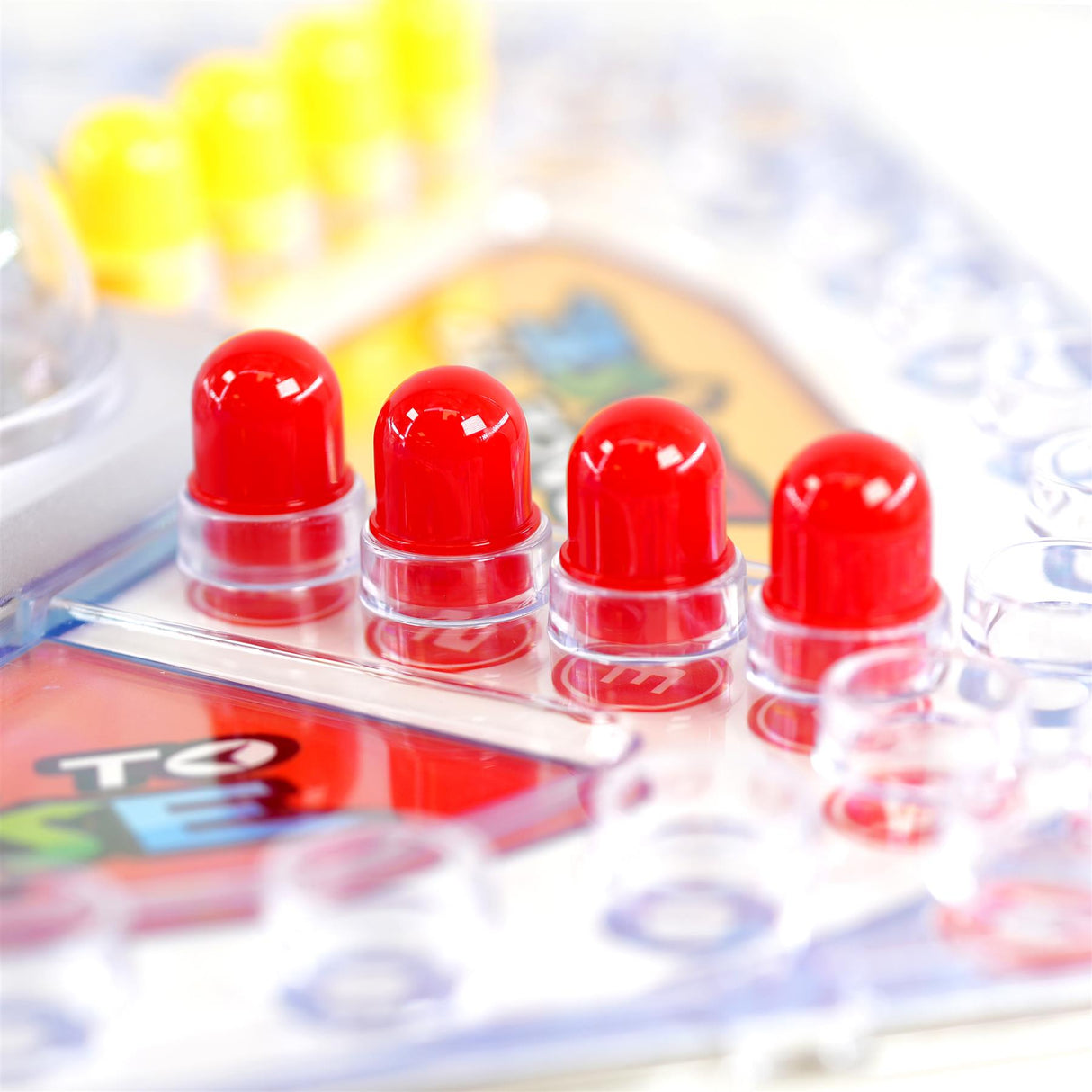 Red plastic markers are placed in clear holders on a section of the board game.