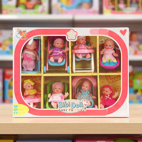 Set of eight miniature baby dolls displayed in individual cradles with various outfits.