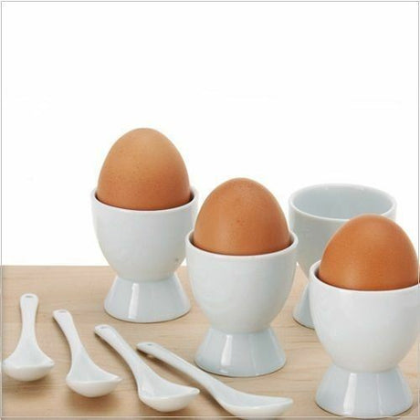 Eight piece porcelain egg cup set with matching spoons.