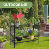 Two-tiered metal plant stand with plants on shelves in a yard.