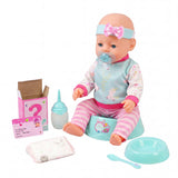 Doll sitting with a playset including clothes, diaper station, bottle, bowl, and spoon.