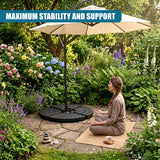 Round patio base supports a large parasol positioned in a lush, flowered garden setting.