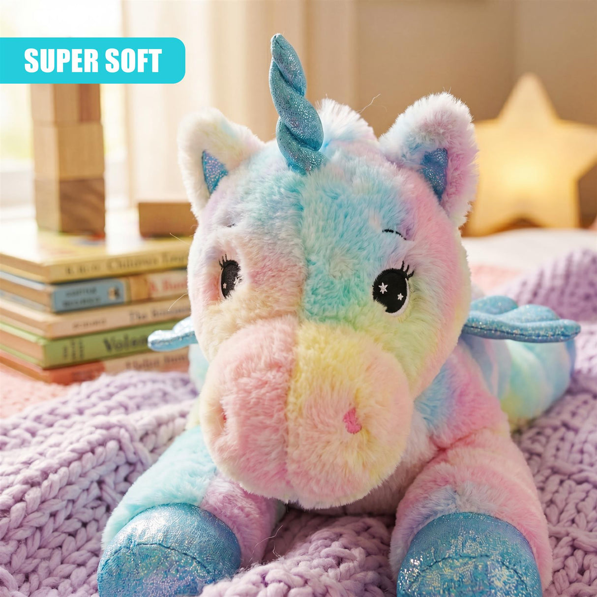 Fluffy unicorn stuffed toy with rainbow coloration resting on purple textured fabric.