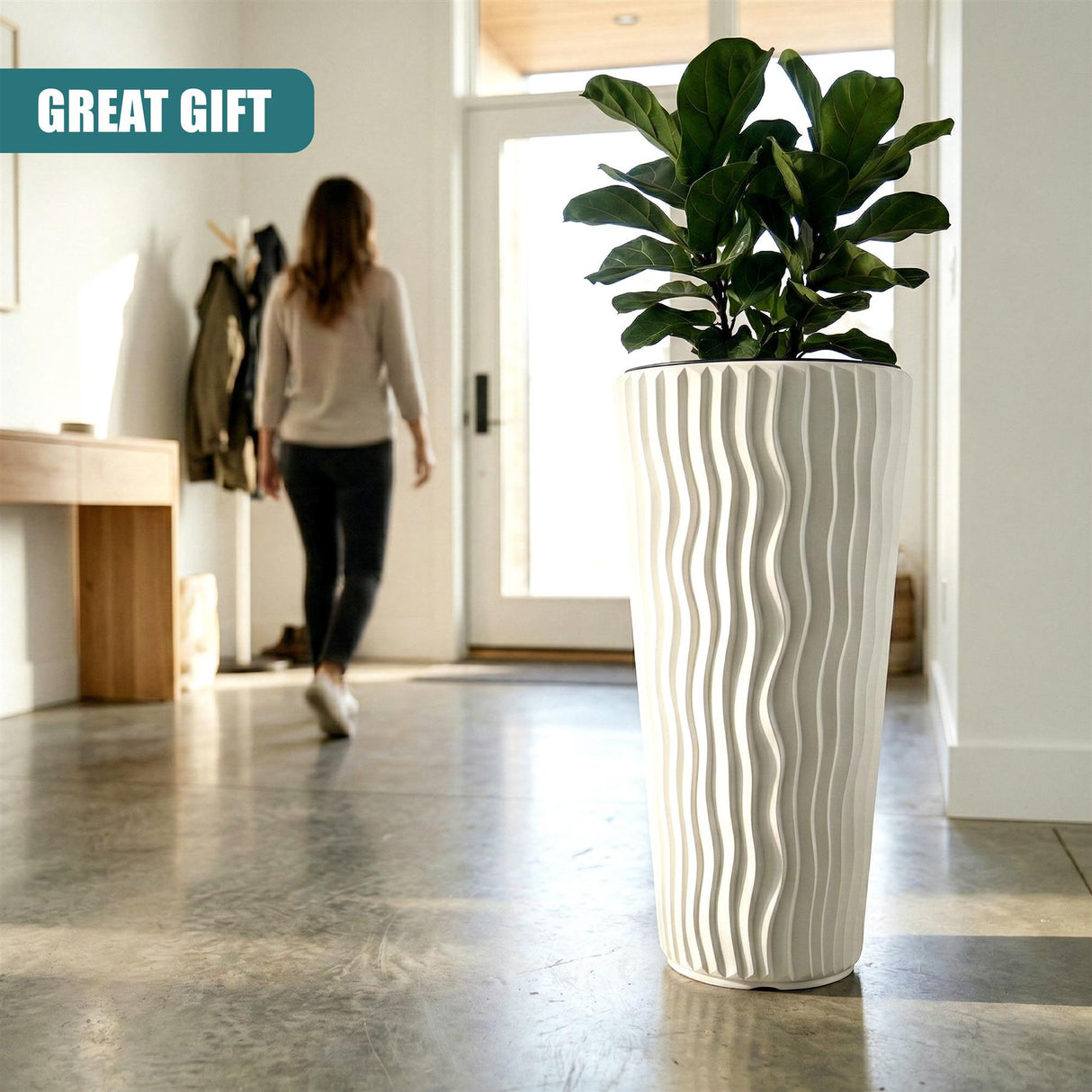 Tall, ribbed white planter pot holding a lush, green houseplant in an indoor setting.