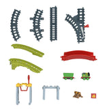 Multiple grey and green train track pieces, curves, straight sections, and small rolling stock models.
