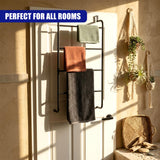 Black metal towel rack on a white door holds multiple towels in various colors.
