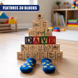 Stacked wooden blocks spelling DAVE are displayed next to a pair of blue and yellow star slippers.