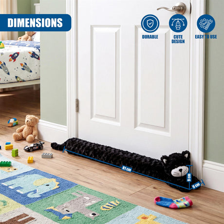Black, plush, cat-shaped draught excluder placed along the base of a white interior door.