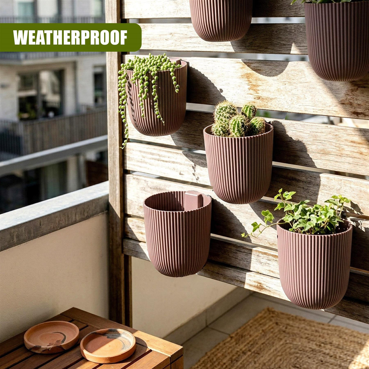 Several ribbed brown planters holding various succulents are mounted on a wooden slat wall.