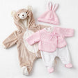 Plush brown bear onesie, pink bunny hat, and white patterned top and pants are displayed together.