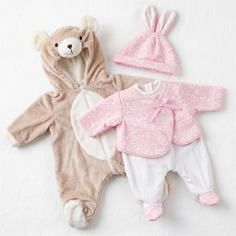 Plush brown bear onesie, pink bunny hat, and white patterned top and pants are displayed together.