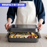 An open metal roasting pan holds roasted fish, potatoes, and various vegetables.