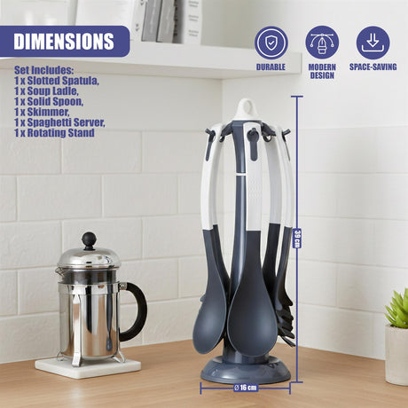A silver kitchen pot sits next to a standing organizer holding several cooking and serving utensils.