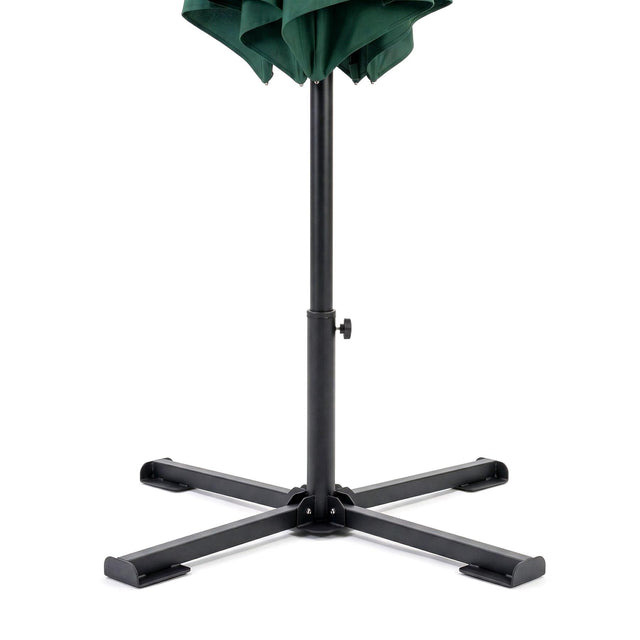 Folding dark green parasol with a black metal center pole and sturdy supporting base.