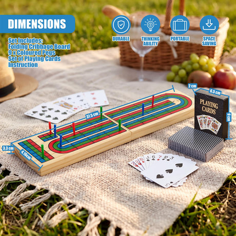 A wooden folding cribbage board game with coloured pegs and playing cards on a picnic blanket outdoors