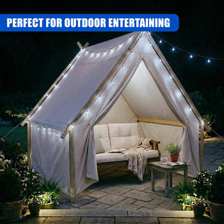 White canopy tent illuminated with numerous small lights, showing an inner bench and surrounding plants.
